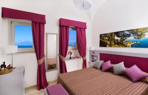 a bedroom with a bed with purple drapes at Capri Wine Hotel in Capri