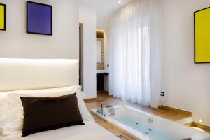 A bed or beds in a room at Lighea aqua suites and breakfast