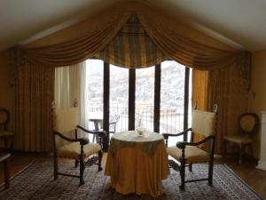 a dining room with a table and chairs in front of a window at FILIPPONE HOTEL&RISTORANTE in Gioia dei Marsi
