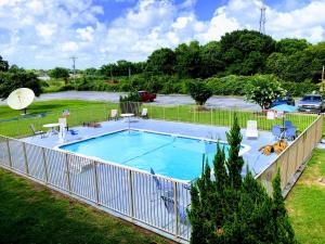 a large swimming pool with a fence around it at Motel 6-Clute, TX in Clute