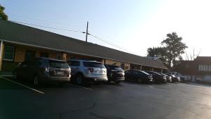 a parking lot with cars parked in front of a building at Budget Inn Tonawanda in Tonawanda