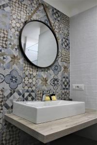 a bathroom with a white sink and a mirror at Anima Migrante in Naples