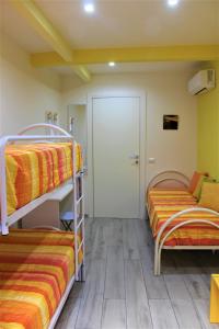 two bunk beds in a room with a door at Anima Migrante in Naples