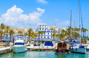 a group of boats docked in a marina with a building at BELLA VISTA in Estepona