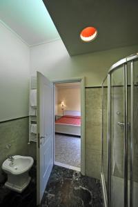 a bathroom with a toilet and a shower and a bedroom at B&B La Terrazza in Brescia