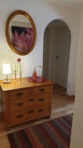 a dresser in a room with a mirror on the wall at Haus Ella in Homburg