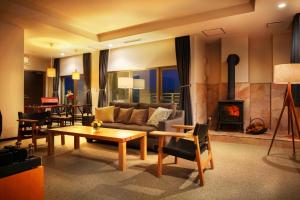 a living room with a couch and a fireplace at Villa Concordia Resort & Spa in Hakodate