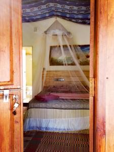 a bedroom with a bed with a canopy at Margarita kitesurfing school Sri Lanka in Kalpitiya