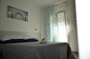 a bedroom with a large bed with a window at B&B EDEN OGLIASTRA in Tortolì
