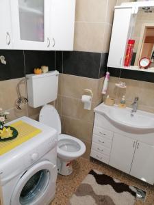 a bathroom with a white toilet and a sink at Apartman Nena in Nova Varoš