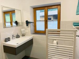 a bathroom with a sink and a mirror at Allgäu-Feeling in Rettenberg