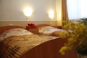 two beds in a hotel room with a red bag on them at Tsar Gory Guest House in Ruskeala