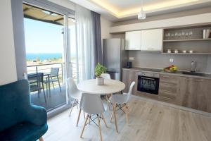 a kitchen and dining room with a table and a view of the ocean at Alikon Adult-Only in Neos Marmaras