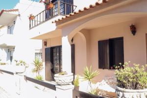 a house with potted plants on the balcony at Casa Beta in Peniche