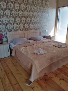 a bedroom with a bed with two towels on it at Elco in Zugdidi
