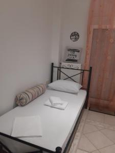 a small bed in a room with a white mattress at Thessaloniki Center Studio in Thessaloniki