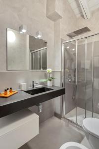 a bathroom with a sink and a shower at Hotel Pironi in Cannobio