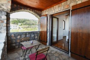a room with a table and chairs and a window at Villa Shanti - Pool, Beach & Basketball court in Luštica