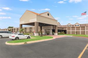a building with a car parked in front of it at LeBossier Hotel in Bossier City