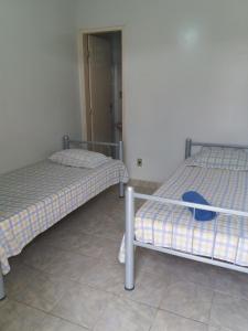 duas camas sentadas uma ao lado da outra num quarto em Pousada Casarrara em Itaberaba