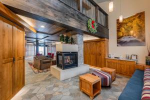 a living room with a fireplace and a couch at Creekside at Beaver Creek in Beaver Creek