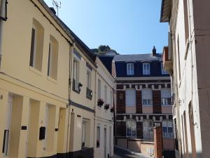 an alley in an old town with buildings at Repaire des Corsaires Normands in Le Tréport