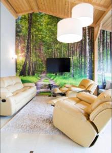 a living room with a wall mural of a forest at Apartament Platinum 1 in Ustroń