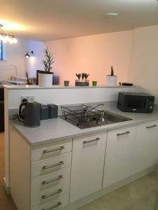 a kitchen with a sink and a counter top at The Old Railway Quarter in Swindon