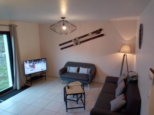 a living room with a couch and a tv at Ax Sweet Mountain - 3ch et 2 sdb - jardin centre village in Ax-les-Thermes