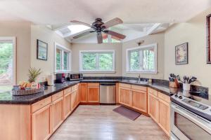 a kitchen with wooden cabinets and a ceiling fan at Tiki Hale in Princeville