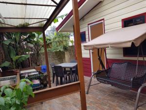 a patio with an umbrella and a table and chairs at Villa Viray in Baguio