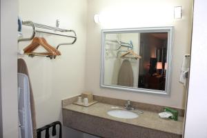 
a bathroom with a mirror and a sink at Americas Best Value Inn Tuscaloosa in Tuscaloosa
