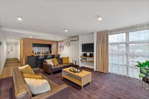 a living room with a couch and a table at Lakefront Marina Apartment in Queenstown