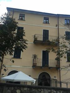 a building with an umbrella in front of it at La Pania in Stazzema