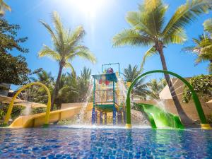 a water park with a water slide in a pool at The Mulia in Nusa Dua