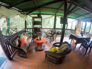 a living room with couches and chairs and a table at Hospedaje La Naciente in Turrialba