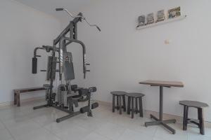 a room with a gym with stools and a table at RedDoorz Plus near Alun Alun Kuningan in Kuningan