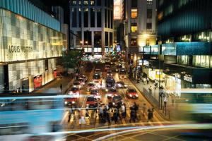 a busy city street with traffic at night with at Butterfly on Wellington, Central in Hong Kong