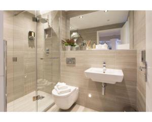 a bathroom with a toilet and a sink at Serenity Inn the City in York +5 photos