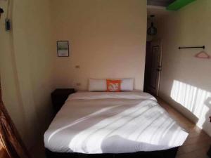 Postel nebo postele na pokoji v ubytování Hearty Homestay