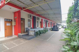 a row of buildings with cars parked on a street at RedDoorz near IPDN 2 in Sumedang