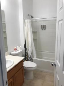 a white bathroom with a toilet and a sink at Spacious 3BD,2BA, ideal for families! in Santa Rosa