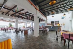 a dining room with tables and chairs in a restaurant at RedDoorz Plus at Hotel Metro Kalibo in Kalibo