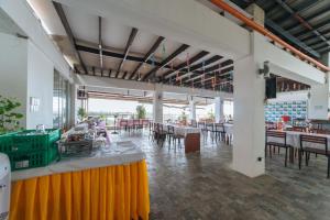 a dining room with tables and chairs in a building at RedDoorz Plus at Hotel Metro Kalibo in Kalibo