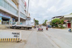 a street with a truck and motorcycles on the road at RedDoorz Plus at Hotel Metro Kalibo in Kalibo