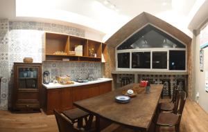 a kitchen with a large wooden table and a counter at Saigon1984 Vintage Private Home Central District 1 with 6 bedrooms and 6 bathrooms in Ho Chi Minh City +22 photos