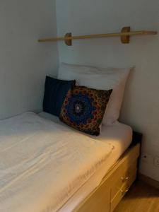 a bed with a pillow sitting on top of it at Mazot Zermatt in Zermatt