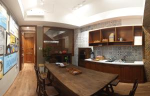 a kitchen with a large wooden table and chairs at Saigon1984 Vintage Private Home Central District 1 with 6 bedrooms and 6 bathrooms in Ho Chi Minh City
