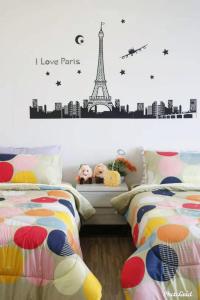 a bedroom with two beds and the words i love paris at Setapak @ Zeta Suite in Kuala Lumpur