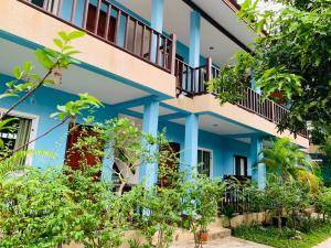a building with blue columns and plants at Zam Zam House in Ko Lanta
